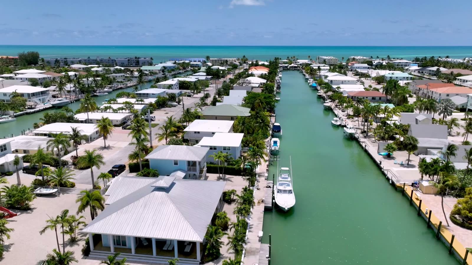 Aerial of a suburban neighborhood with hurricane-damaged roofs