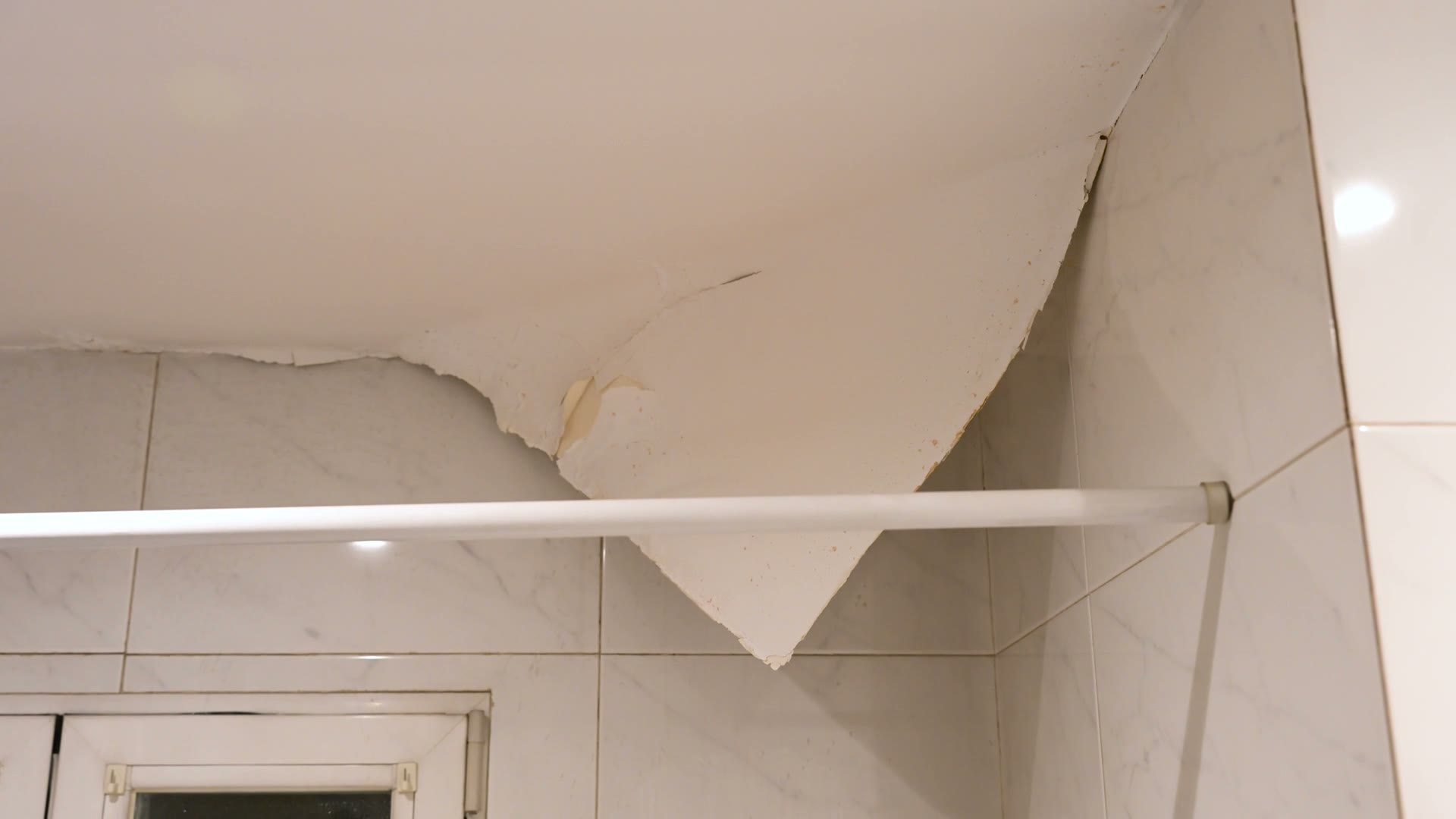 Water staining spreading across an interior ceiling and walls, the damage behind a denied Dunedin, FL water damage insurance claim