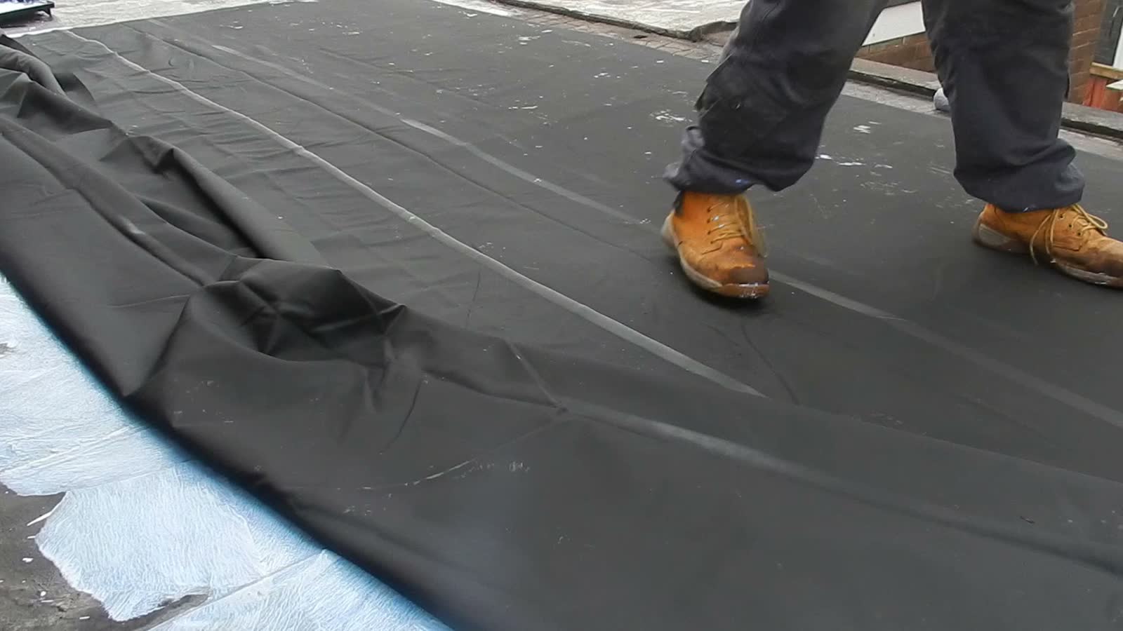 roof-damage-claim-roofer-applying-black-sealant-push.mp4