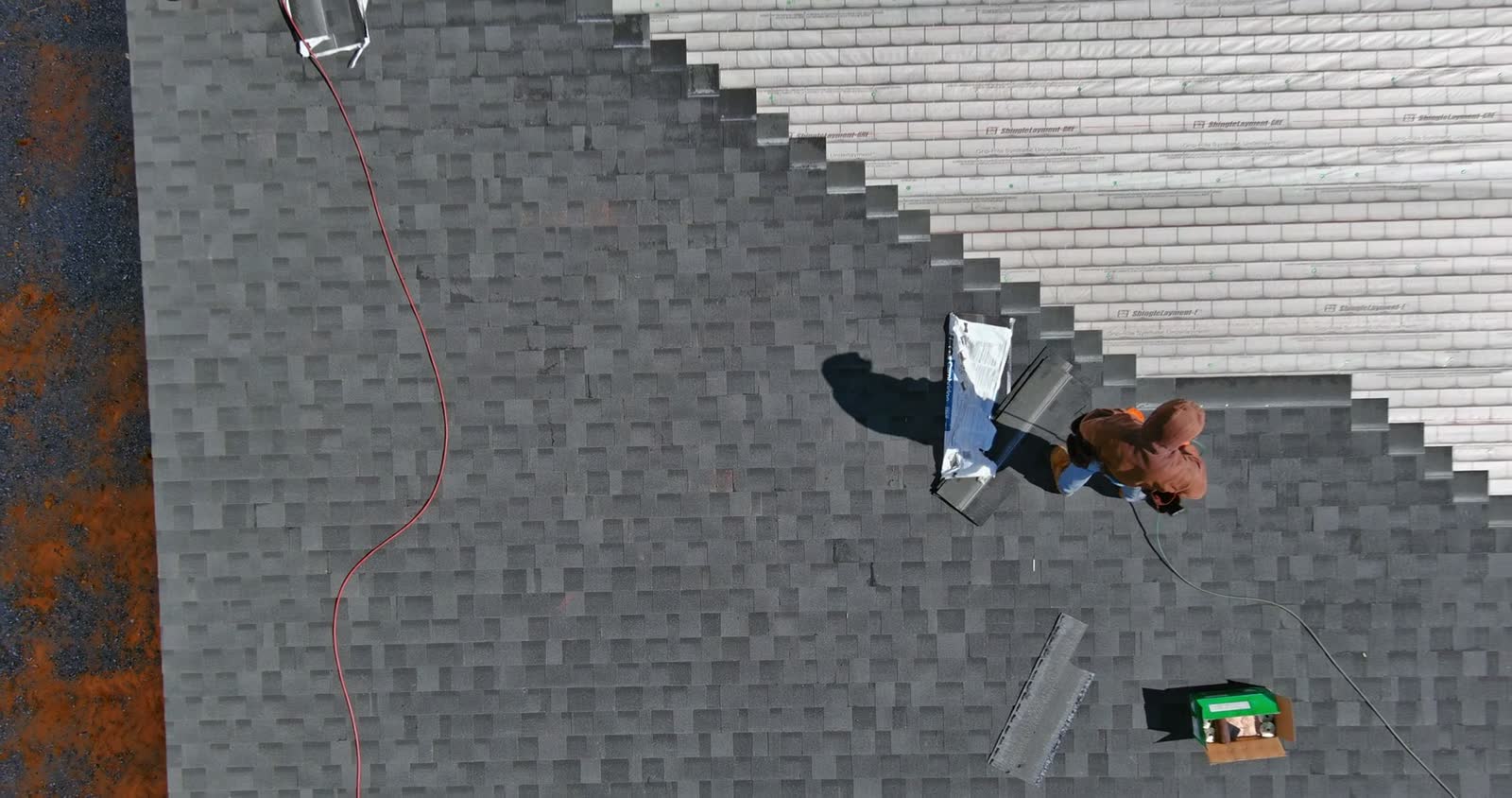 roof-damage-claim-workers-install-grey-shingles-aerial.mp4