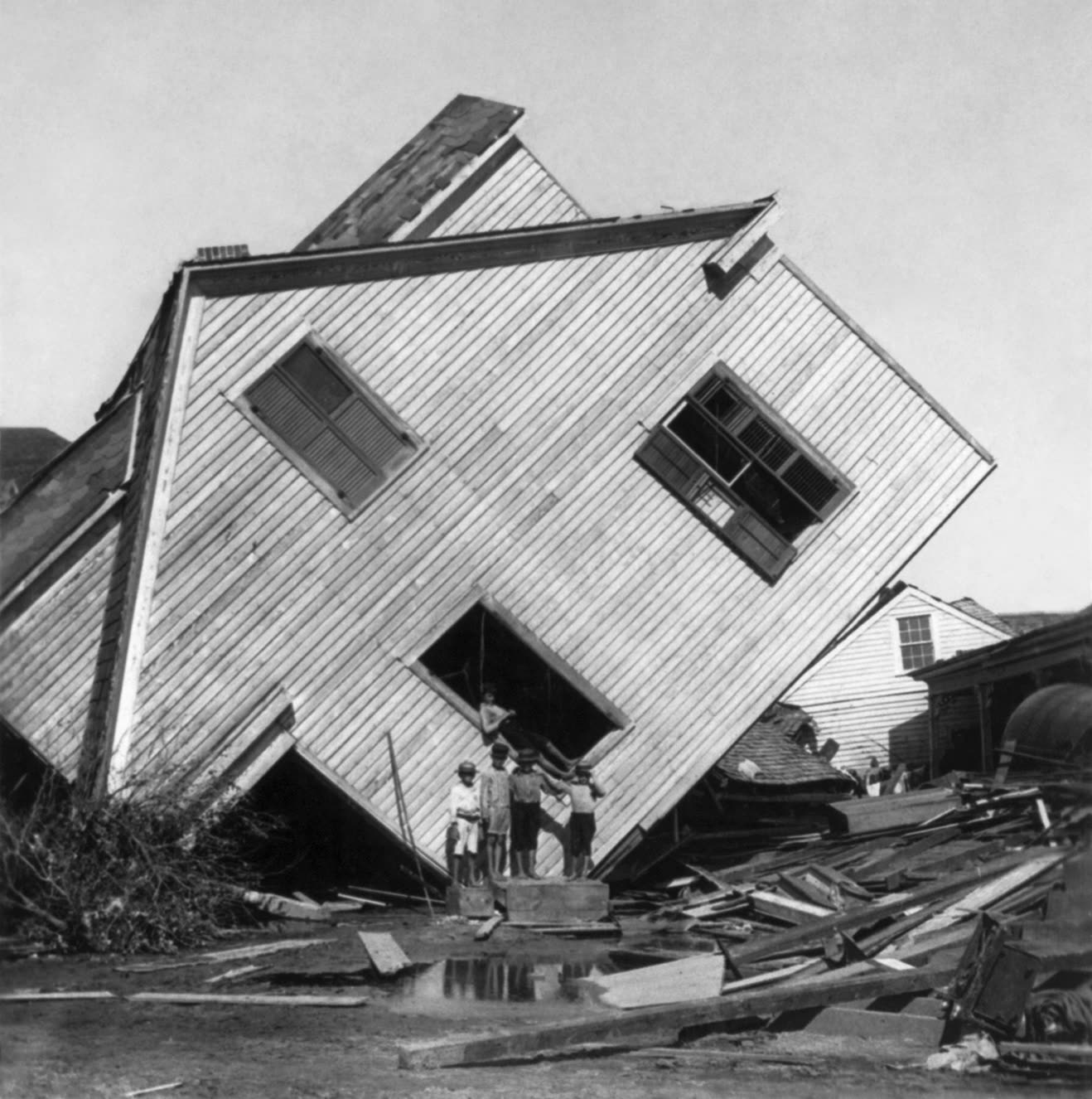 A house tipped off its foundation by the storm surge, Galveston's highest ground stood 8.7 feet above sea level