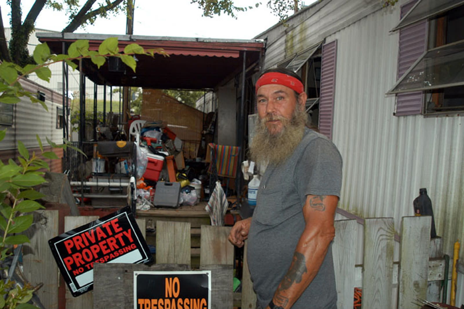 A Richmond-area resident surveys severe damage at Walker Village trailer park after Gaston's flood