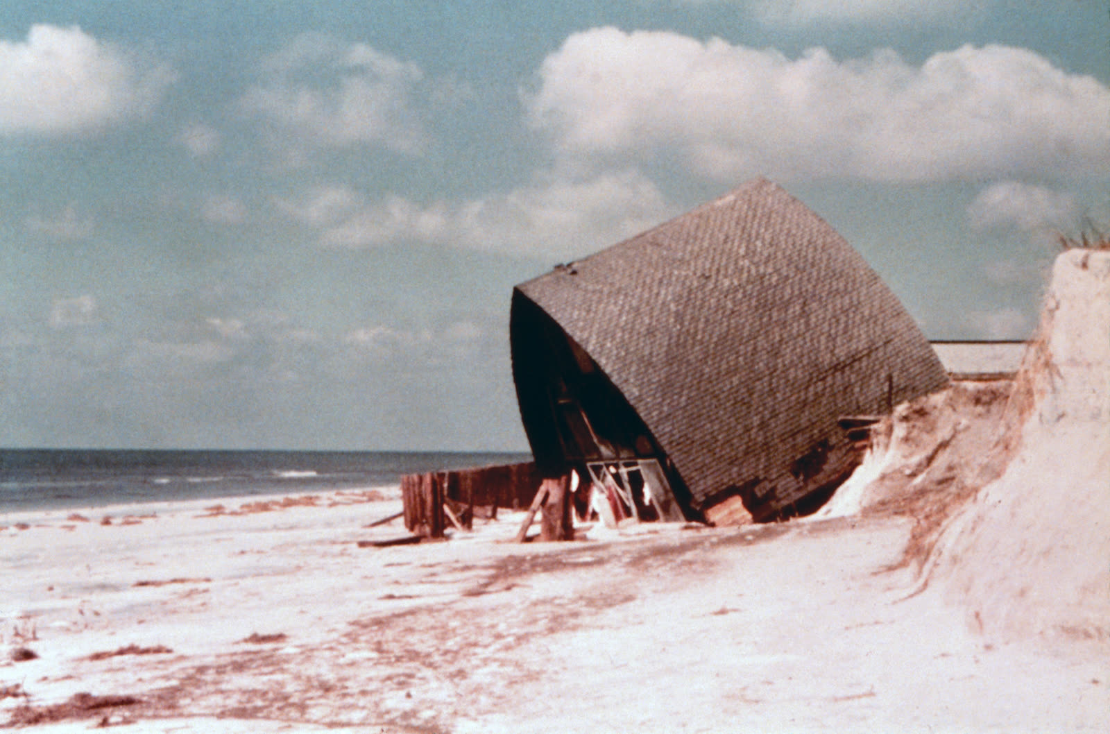 Beach house demolished by surge and waves; structures seaward of the state setback line failed at far higher rates