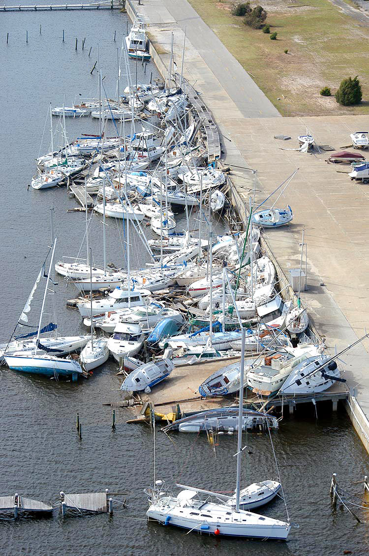 Boats piled ashore at the Naval Air Station Pensacola marina, the base sustained $800-900 million in damage